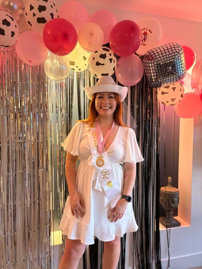 The bride-to-be posing in her hen party cowgirl theme outfit, wearing a chic cowgirl hat and embracing the fun, country-glam vibes of her special hen do. A perfect cowgirl Insta-worthy moment!