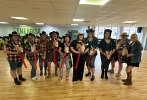 Hens having a blast at a line dancing hen do, taking part in a fun Sashay Dance class filled with laughter, music, and celebration
