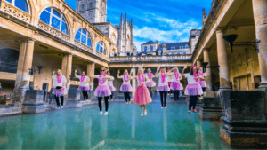 A lively group of hens enjoying a fun dance class in Bath, celebrating with energy and laughter during a hen party dance class. The scene captures the excitement and joy of a hen party dance class in Bath, offering a memorable experience for bridesmaids and guests. Perfect for those looking for dance hen parties in Bath or dance classes for hen parties in Bath.