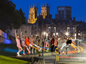 Group of women celebrating in a York hen party dance class, dressed in themed outfits, perfect for fun and memorable dance classes in York.