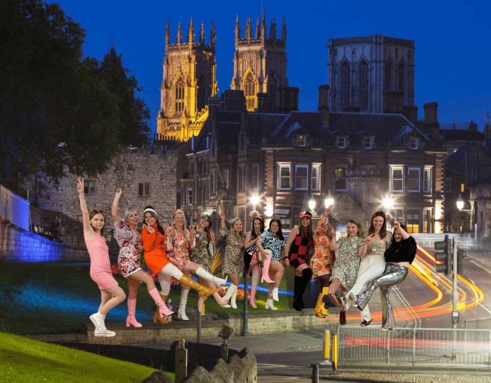 Group of women celebrating in a York hen party dance class, dressed in themed outfits, perfect for fun and memorable dance classes in York.