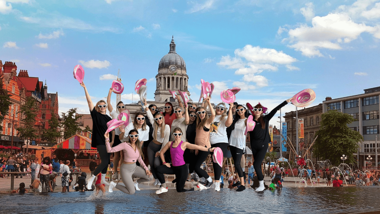 A group of excited women enjoying a lively hen party dance class in Nottingham. They are laughing, dancing, and celebrating in a fun-filled studio setting. Perfect for dance hen parties in Nottingham!