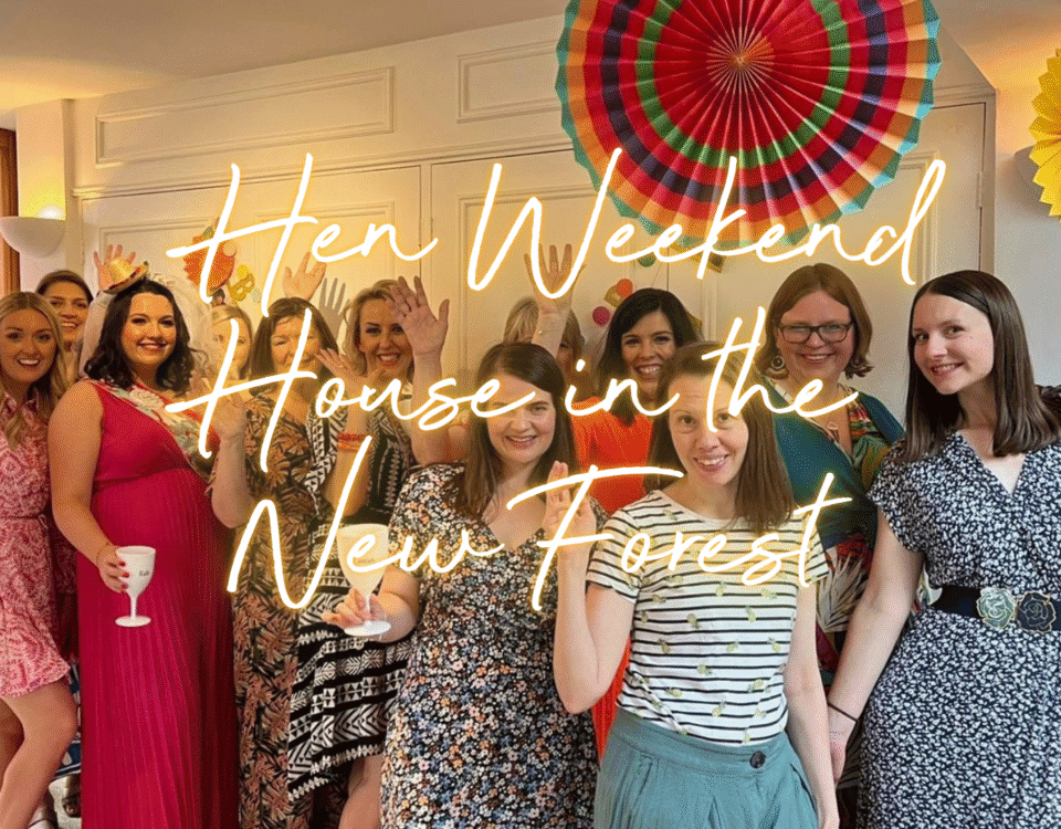 Hen weekend house in the New Forest: hen group in the lounge of a country cottage celebrating with a glass for fizz.